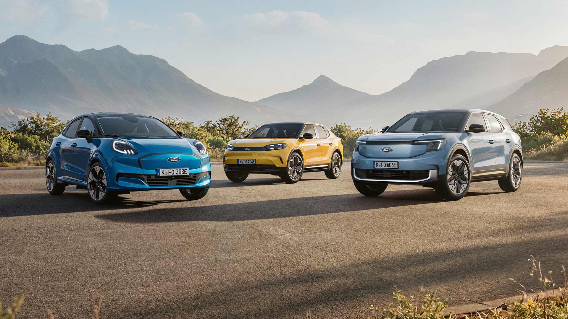 Puma Gen-E, Capri und Explorer auf einer Straße vor einer Küstenlandschaft.