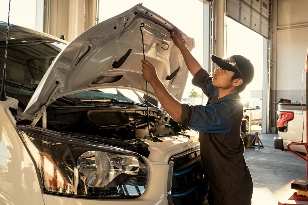 Ford-Mechaniker führt Wartungsarbeiten an einem Ford Transit Transporter durch.